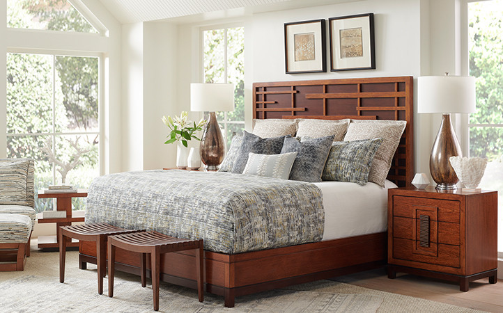 Elegant Pan-Asian fretwork on the headboard is highlighted by a contrasting dark walnut back panel.