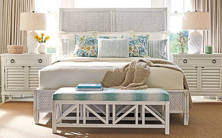 Ocean Breeze bedroom features a white king bed, two nightstands, and a while bench.