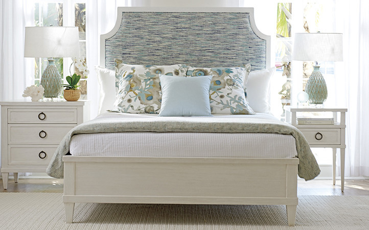 Ocean Breeze bedroom features bed with multi-color upholstered headboard and two nightstands.