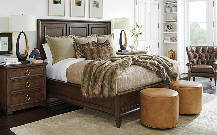 Featuring bed, two nightstands, two ottomans, and a chair.