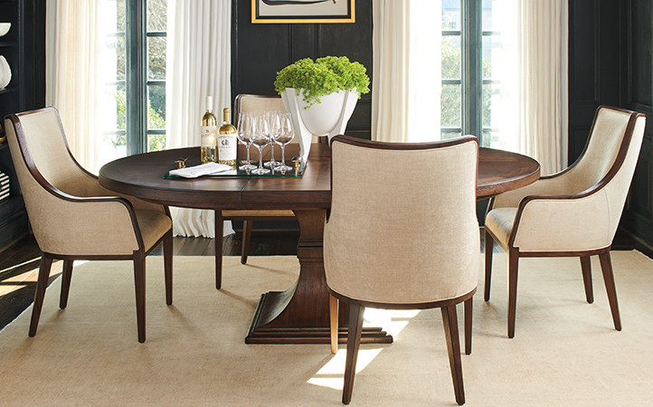 Silverado dining room features a round dark brown dining table and four beige upholstered chairs.