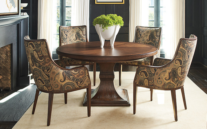 Silverado dining room features a round dark brown dining table with four multi-color upholstered chairs.